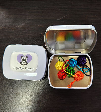Notion Tin with colored yarn balls